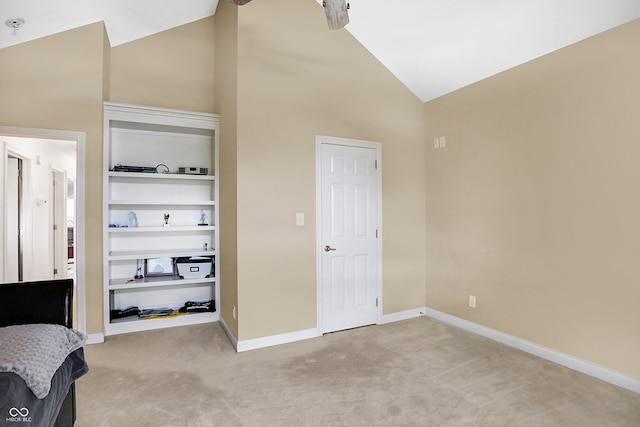 bedroom featuring high vaulted ceiling and light colored carpet