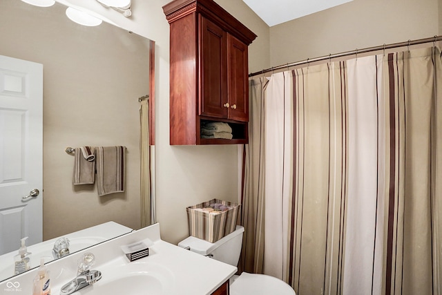 bathroom with vanity, toilet, and walk in shower