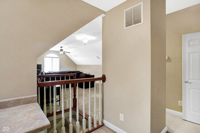 stairway with carpet flooring, vaulted ceiling, and ceiling fan