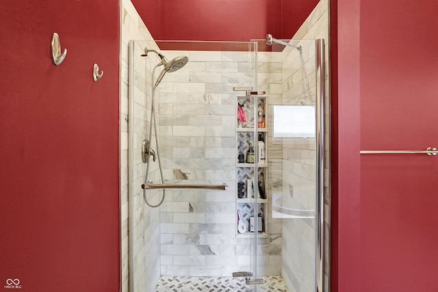 bathroom with a shower with door