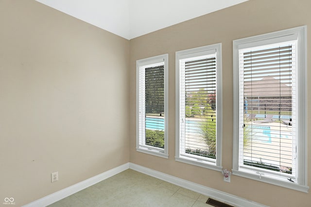 unfurnished room featuring visible vents and baseboards