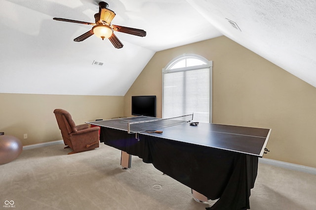 recreation room featuring light carpet, vaulted ceiling, a textured ceiling, and ceiling fan