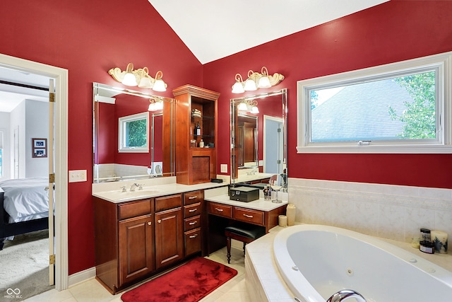 bathroom with lofted ceiling, tile patterned flooring, tiled bath, and vanity