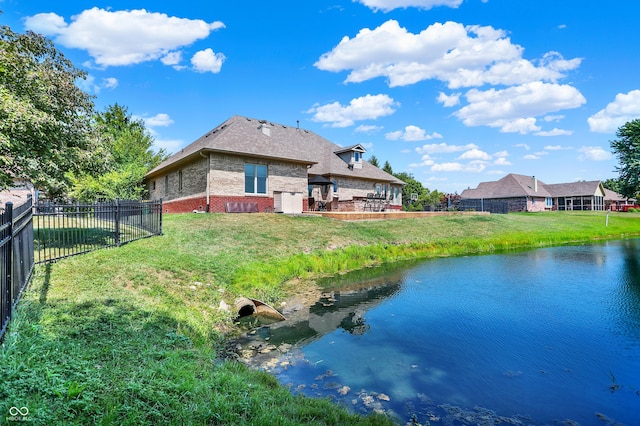 rear view of property with brick siding, a yard, a fenced backyard, and roof with shingles