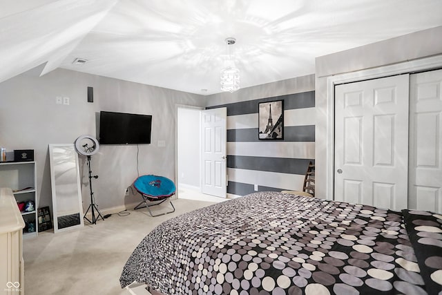 bedroom with lofted ceiling, a closet, and carpet