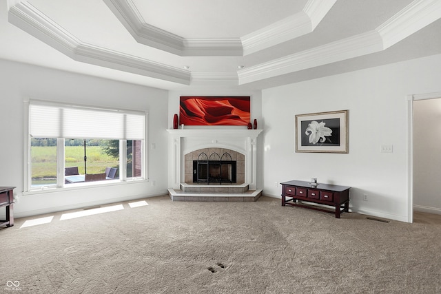 carpeted living room featuring a raised ceiling, ornamental molding, and a fireplace