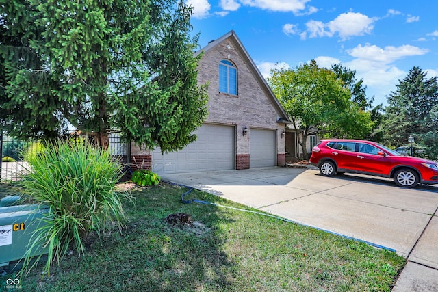 view of side of property featuring a garage, brick siding, driveway, and fence