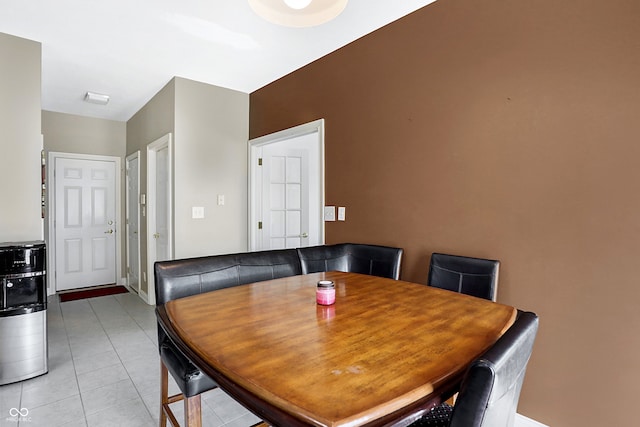 dining space featuring light tile patterned floors and baseboards