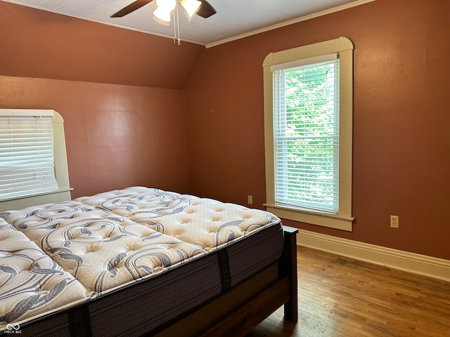 bedroom with multiple windows, ceiling fan, hardwood / wood-style floors, and ornamental molding