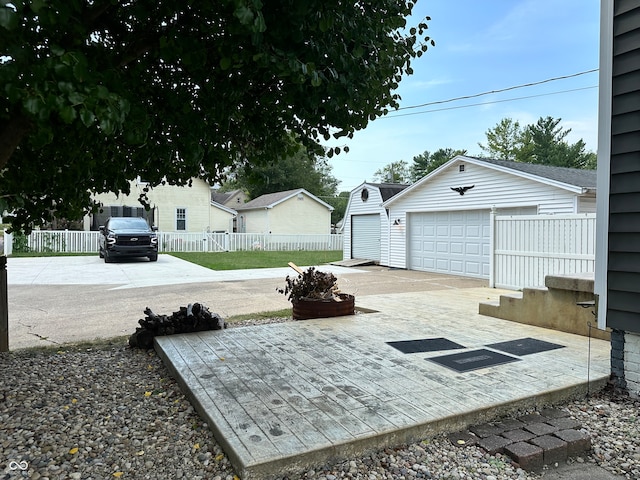 view of yard with a garage and an outbuilding