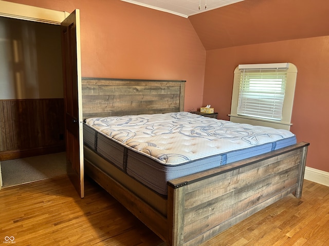 bedroom featuring vaulted ceiling and light hardwood / wood-style floors