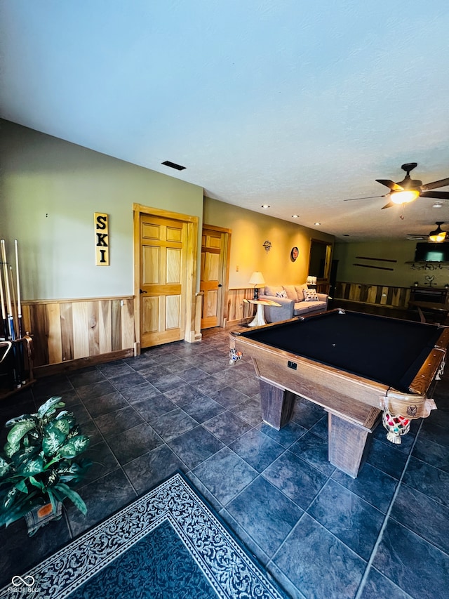 game room featuring billiards, ceiling fan, and wooden walls