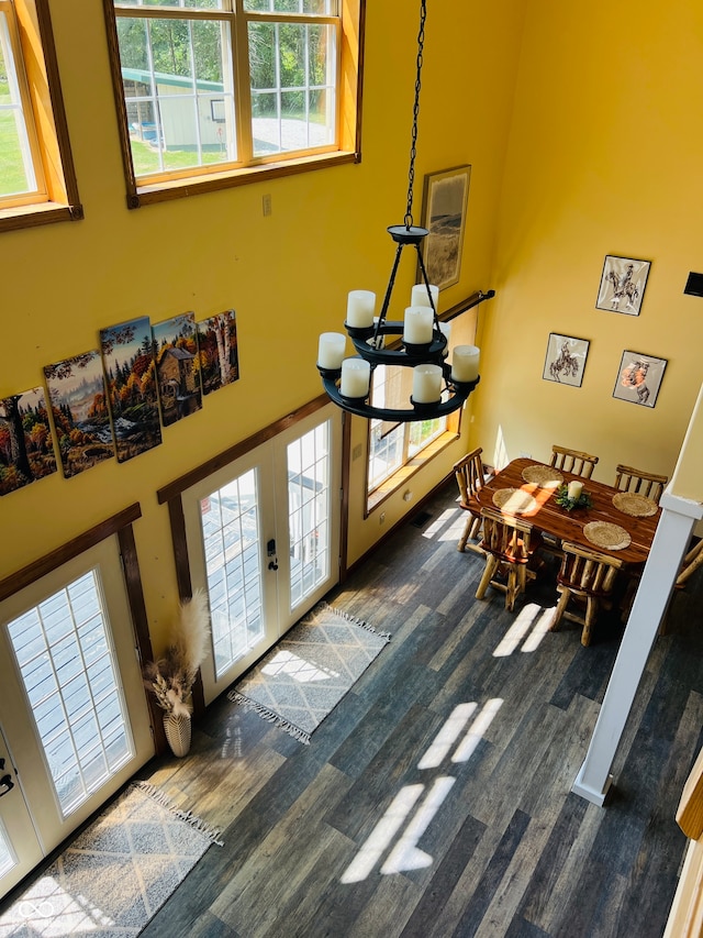 foyer with wood-type flooring, a notable chandelier, and a healthy amount of sunlight