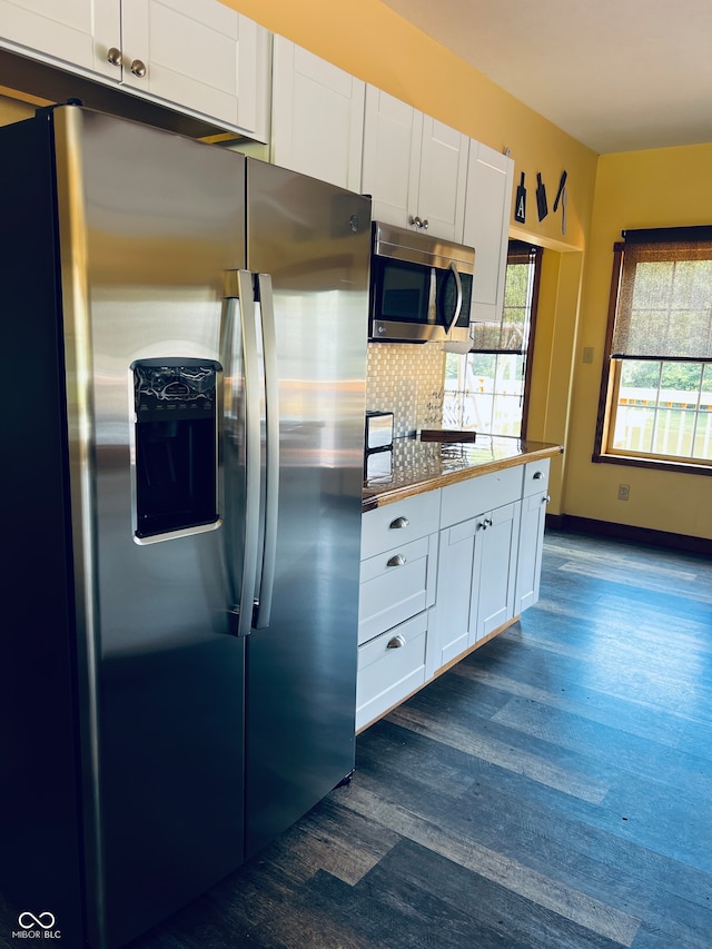 kitchen featuring dark wood-type flooring, stainless steel appliances, backsplash, and white cabinets