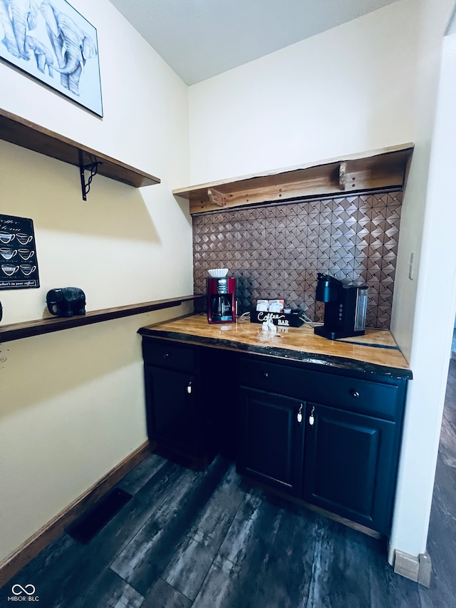 interior space featuring dark hardwood / wood-style floors, decorative backsplash, and butcher block counters