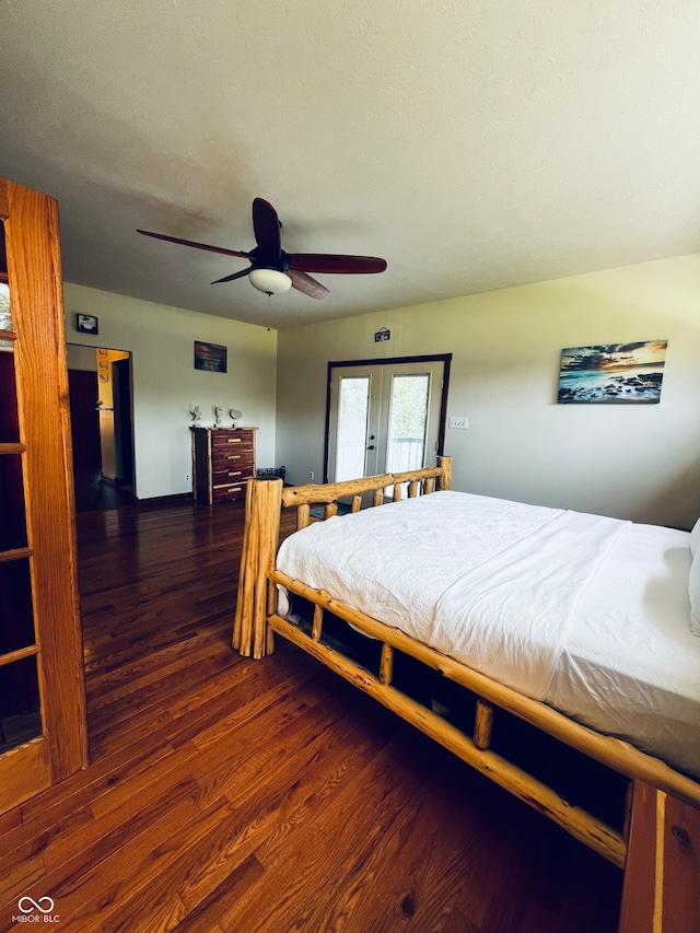 bedroom featuring ceiling fan, dark hardwood / wood-style floors, and french doors