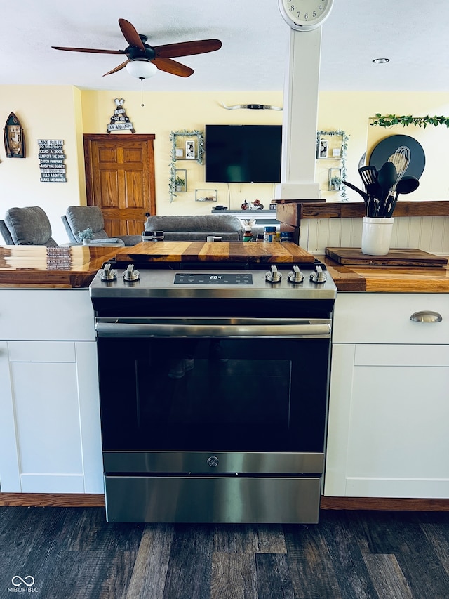 kitchen featuring dark hardwood / wood-style floors, stainless steel electric stove, and white cabinets