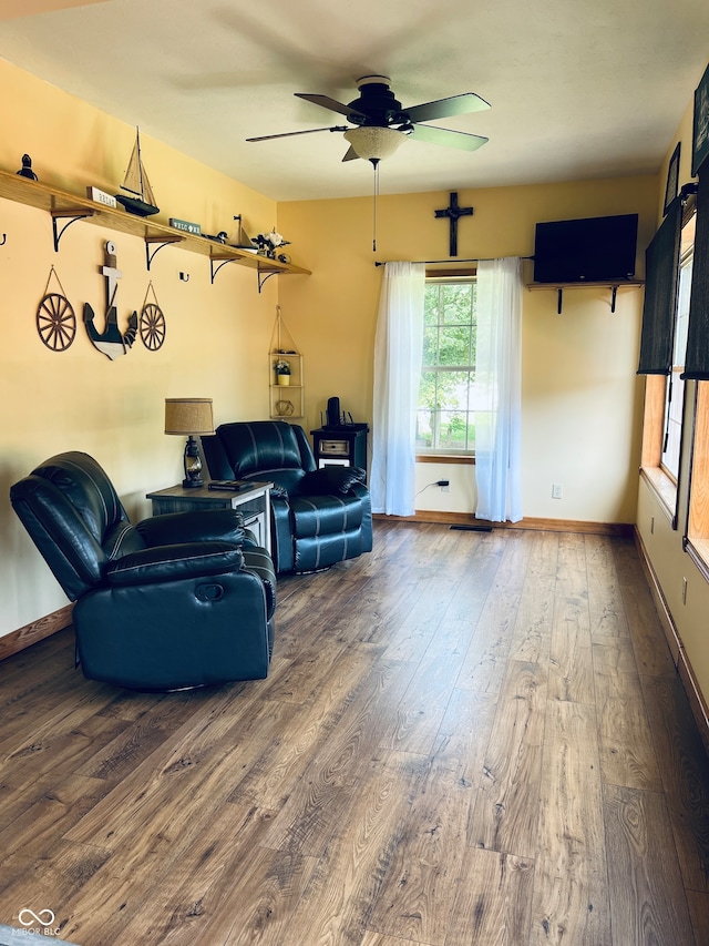 living room featuring ceiling fan and hardwood / wood-style flooring