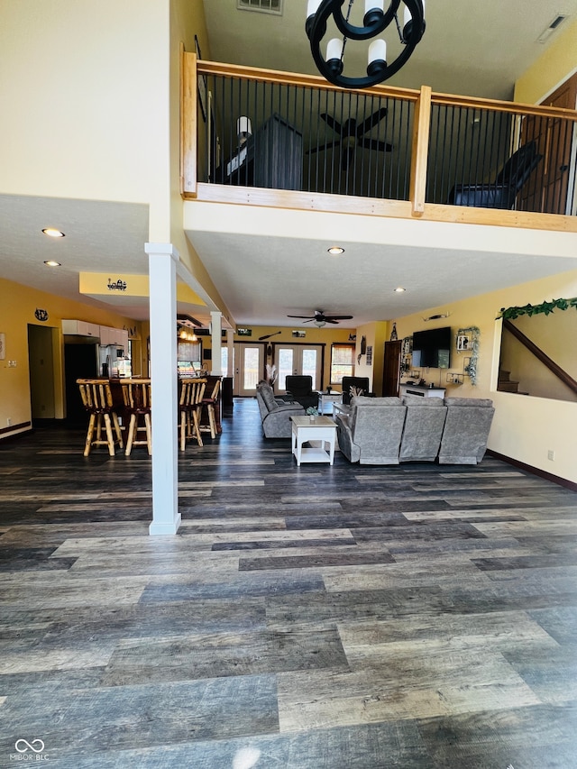 interior space with a towering ceiling and ceiling fan