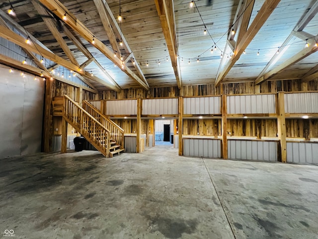 miscellaneous room with concrete floors and vaulted ceiling