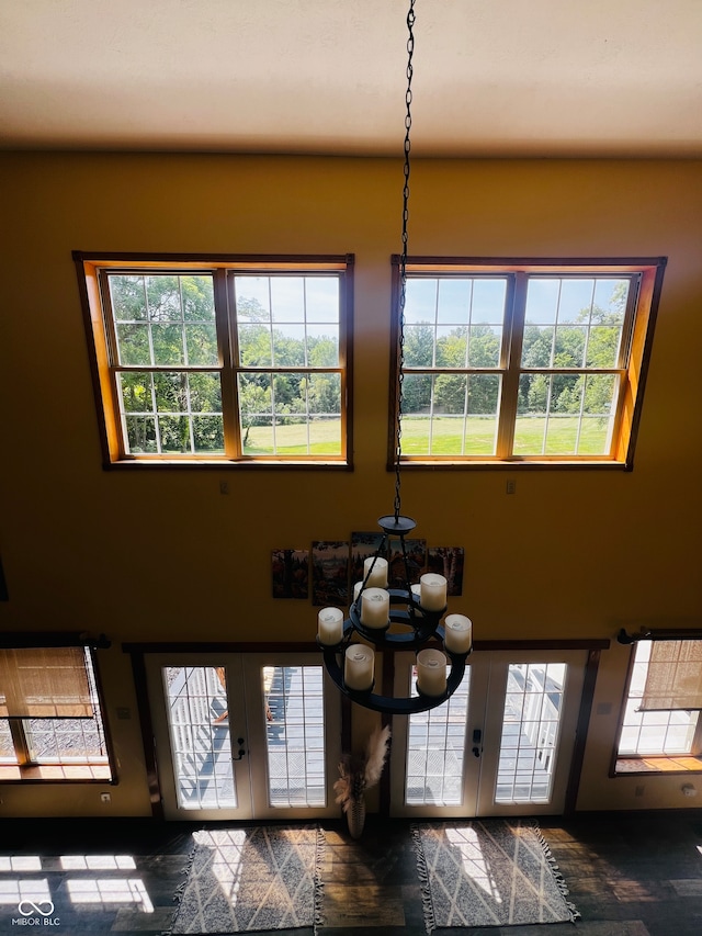 foyer with a wealth of natural light and an inviting chandelier