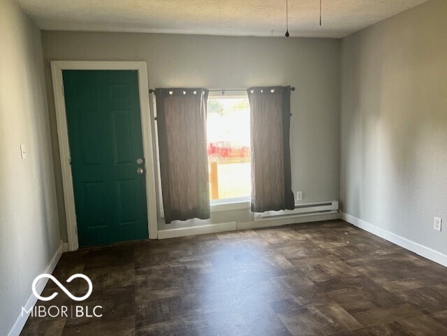 unfurnished room with a textured ceiling