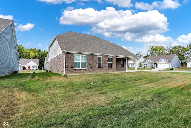 rear view of property with a yard and a garage