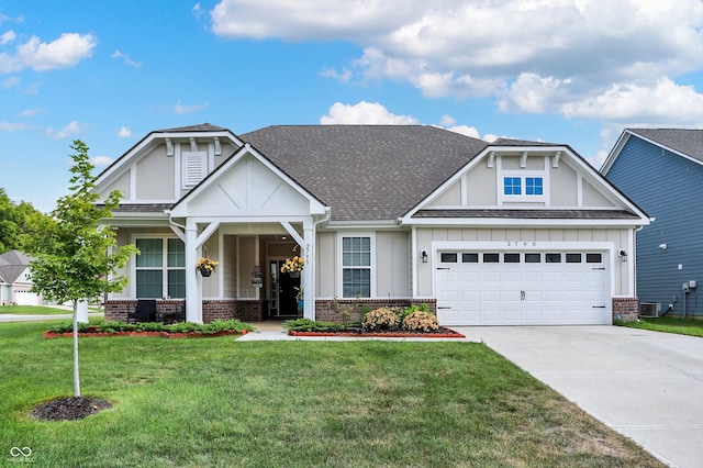 craftsman-style home with covered porch, cooling unit, a garage, and a front lawn