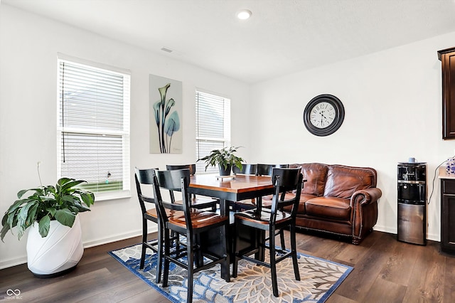 dining area featuring dark wood-type flooring