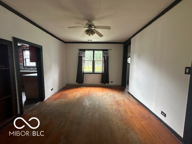 spare room with ceiling fan, ornamental molding, and hardwood / wood-style flooring