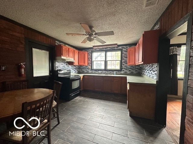 kitchen with range with electric cooktop, ceiling fan, hardwood / wood-style floors, and backsplash