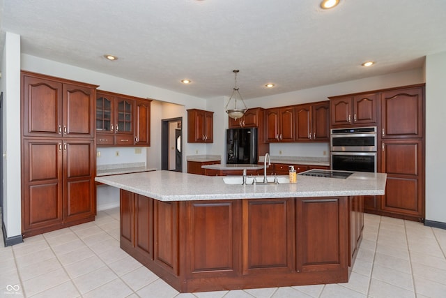 kitchen featuring recessed lighting, a sink, a large island, and black appliances