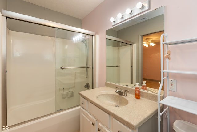 bathroom featuring toilet, enclosed tub / shower combo, visible vents, and vanity