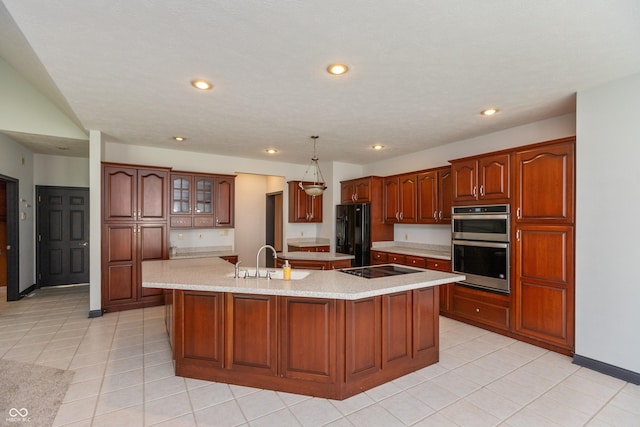 kitchen featuring light tile patterned floors, recessed lighting, a sink, a large island, and black appliances