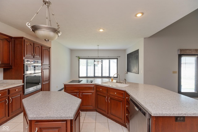 kitchen featuring a large island, stainless steel appliances, a sink, and light countertops