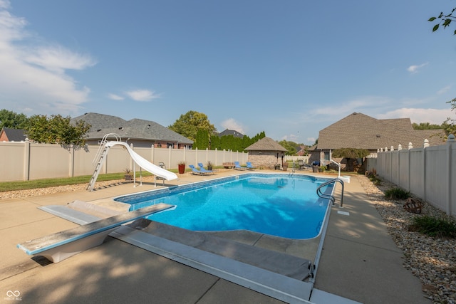 view of pool with a water slide, a fenced backyard, a gazebo, a fenced in pool, and a patio area