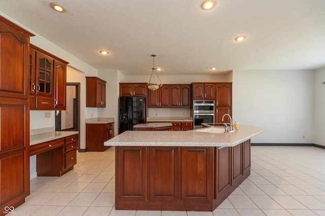 kitchen with black refrigerator with ice dispenser, stainless steel double oven, a large island with sink, a sink, and light tile patterned flooring