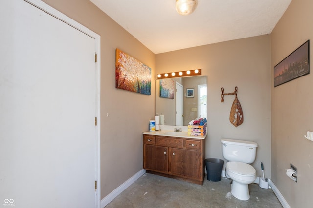 bathroom with concrete flooring, baseboards, and toilet