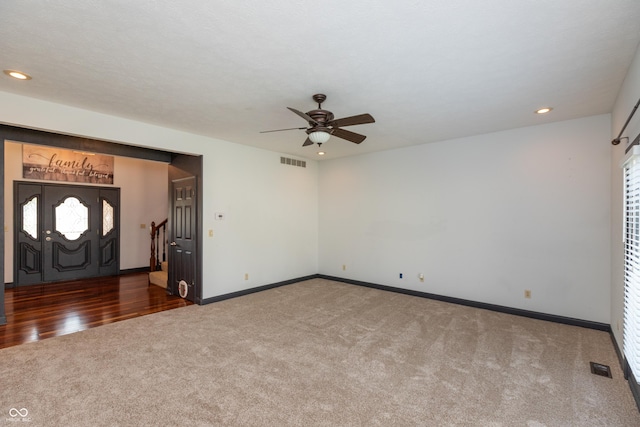 foyer with stairway, carpet, visible vents, and baseboards