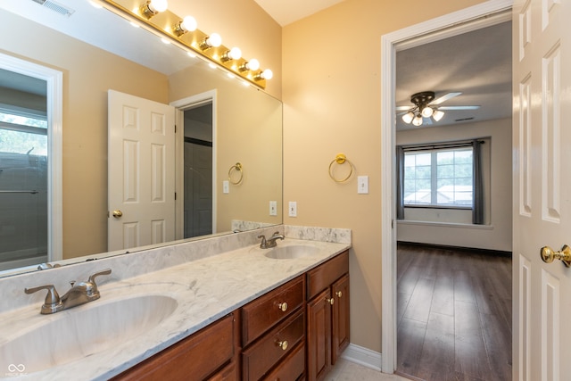 full bathroom featuring double vanity, a sink, visible vents, and a ceiling fan