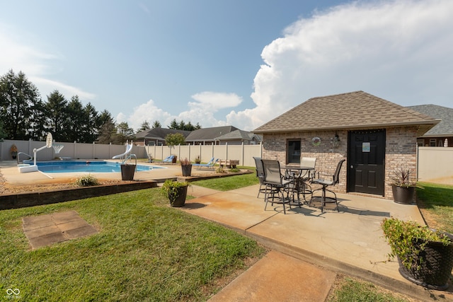 exterior space featuring a fenced backyard, outdoor dining area, and a fenced in pool