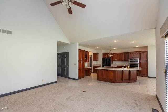 kitchen with light countertops, light carpet, visible vents, and light tile patterned flooring