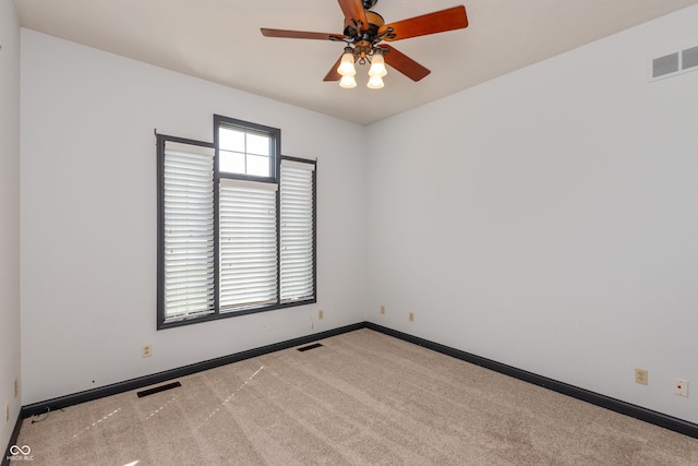 empty room featuring baseboards, visible vents, and carpet flooring