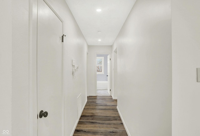 corridor with dark wood-type flooring