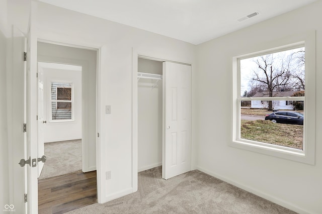 unfurnished bedroom featuring a closet and carpet