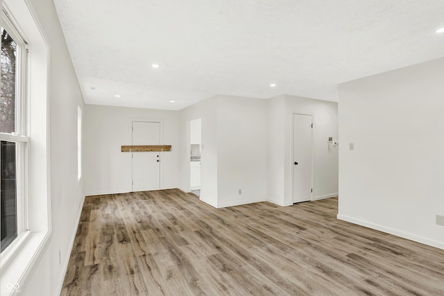 unfurnished living room with light hardwood / wood-style flooring