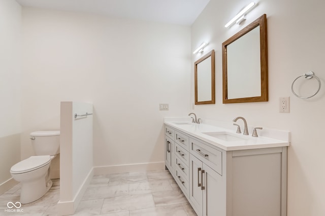full bathroom with marble finish floor, a sink, double vanity, and toilet
