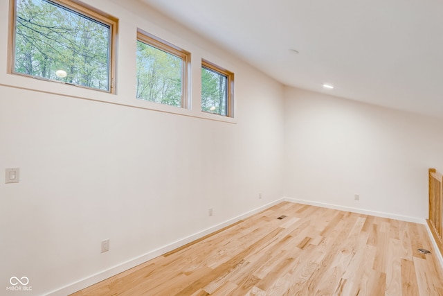 bonus room with baseboards and wood finished floors