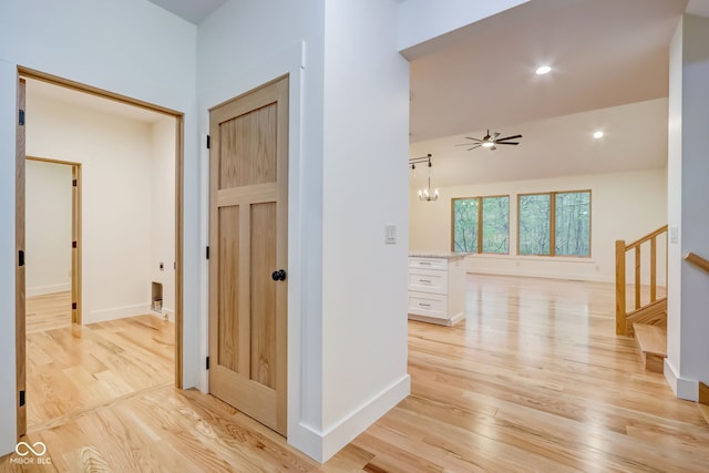 hallway with recessed lighting, baseboards, light wood finished floors, and stairs