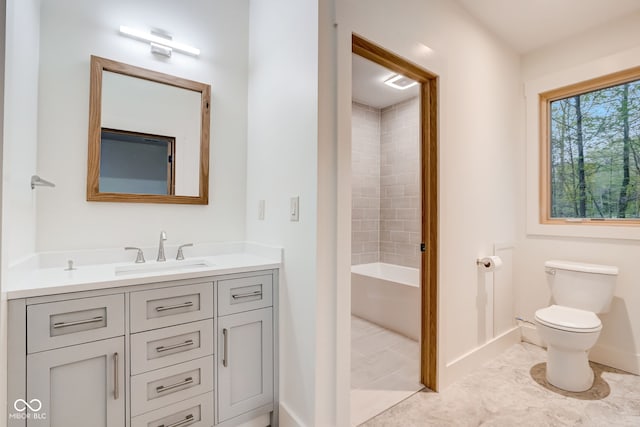 full bathroom with tile patterned floors, toilet, tiled shower / bath combo, and vanity